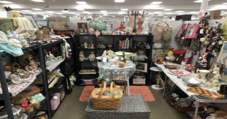 A vendor’s booth at Route 27 Antique Mall sells Cabbage Patch dolls, jewelry, statues, art, and other antiques for customers to observe.